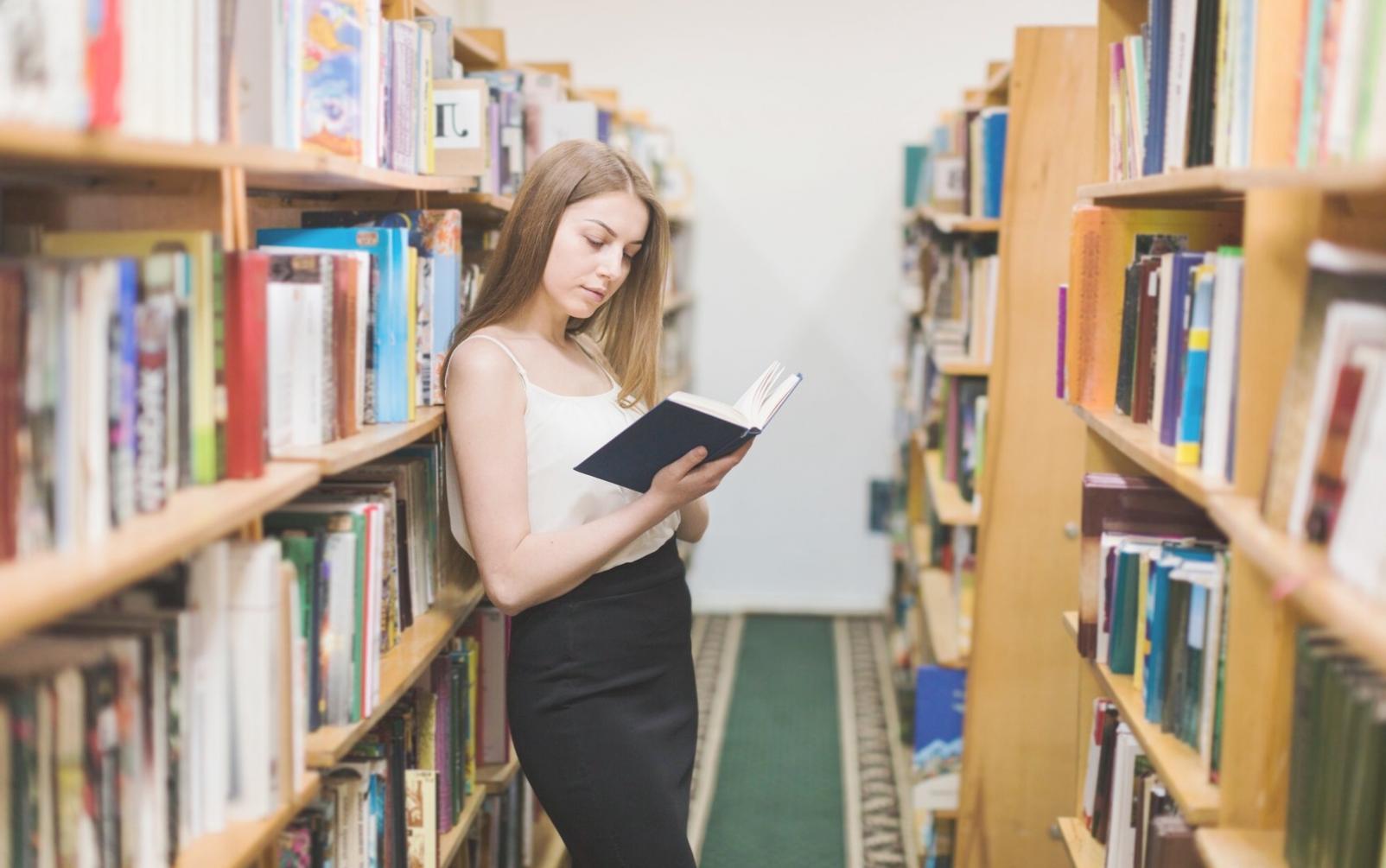 Person reviewing financial documents with calculator and notebook